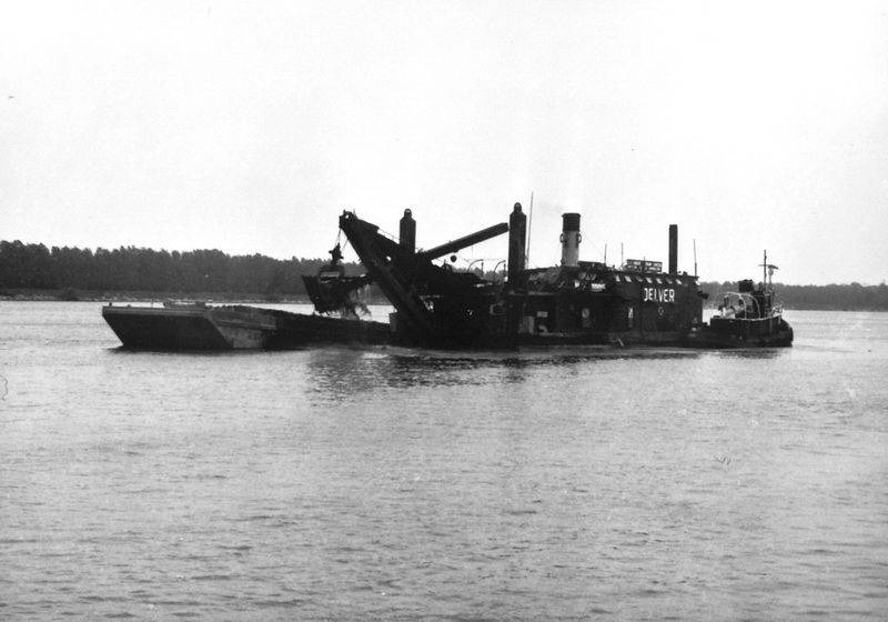 <p>The dredge Delver went down in 30 feet of water off Port Dalhousie while trying to make safe harbour from a sudden gale. Ten men on board of the 18-man crew were rescued by the tugs Alice and Meteor, but one man drowned, William Henry Burt. He would be the first victim of a canal construction that would take at least 137 lives. Pictured above is the Delver in the Welland Canal sometime around 1959. Photo attribution: Courtesy of Cy Williamson, through Skip Gillham</p>