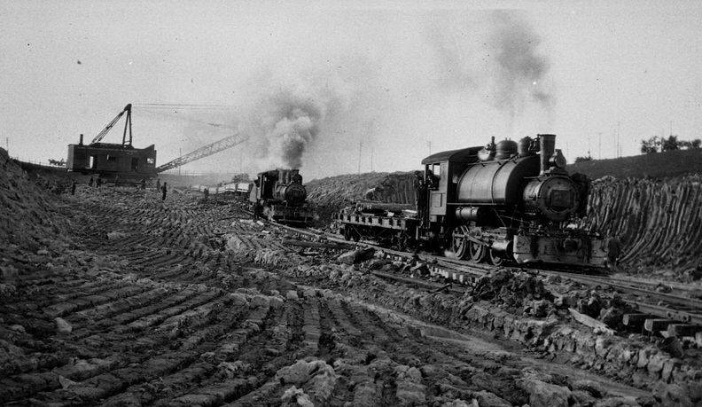 <p>The Construction Railway and other pieces of large earth-moving machinery were indispensable in building the Canal. This image shows a dragline and rail engine that were used in excavating the channel for the future waterway. Unfortunately, almost 20% of all canal fatalities resulted from rail-related accidents. Photo attribution: St. Catharines Museum, Claude Richardson Collection, 2011-N</p>