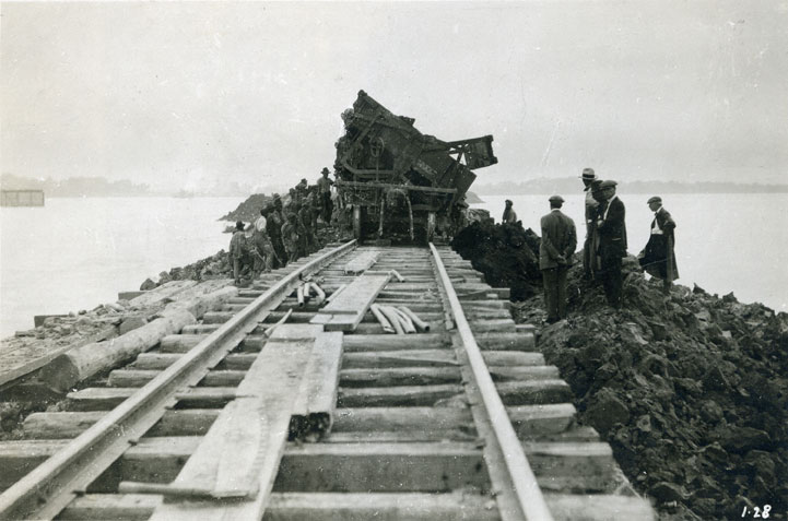 <p>Photo of a dump car at the end of the line in Port Weller, July 1915. Taken from an album belonging to John Laing Weller, the Engineer-in-Charge of Construction of the Fourth Welland Canal from 1912 to 1917. This photo falls within Section 1, a construction zone that extends from the tip of the breakwaters at Port Weller to about Linwell Road, a distance of approx. 4.5 km (2.8 mi.) Photo attribution: St. Catharines Museum, 2006.73.442, from Miss Madelein Muntz</p>